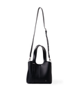 A black leather handbag with a top handle, a long shoulder strap, and a small hanging tassel, shown against a plain white background. Silver hardware.