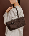 Model styling Rico Rinaldi Mendy Dark Coffee shoulder bag with spacious interior and detachable mini pouch for everyday essentials