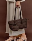 Model carrying Rico Rinaldi Mendy Dark Coffee East-West shoulder bag, premium crocodile embossed PU vegan leather women's work handbag with detachable mini pouch