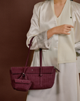 Model wearing Rico Rinaldi Mendy Deep Maroon shoulder bag, minimalist East-West women's handbag for office and everyday use