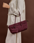 Model carrying Rico Rinaldi Mendy Deep Maroon shoulder bag featuring a spacious interior, secure zip closure and detachable mini pouch