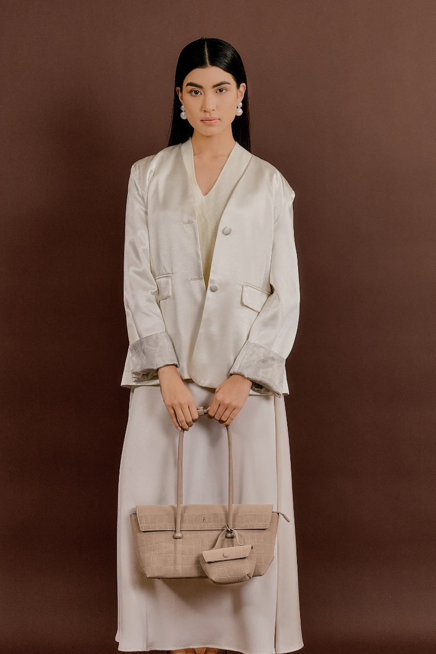 Model carrying Rico Rinaldi Mendy Latte East-West shoulder bag, premium crocodile embossed PU vegan leather women's work handbag with detachable mini pouch