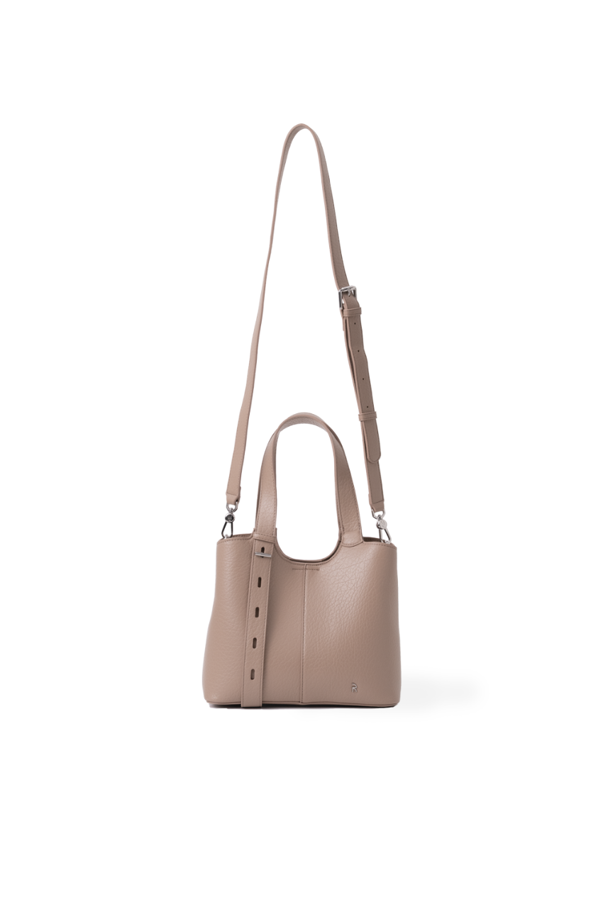 A light brown leather top-handle Rico Rinaldi handbag with a matching shoulder and crossbody strap, displayed against a clean white background. Silver hardware and logo.